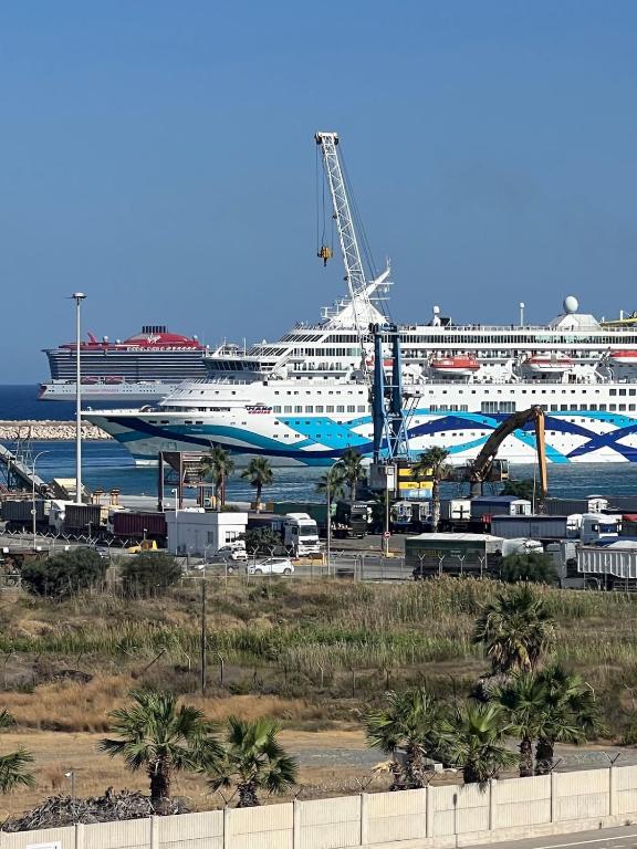 a cruise ship is docked in a harbor at Sea view Appartment in Larnaca