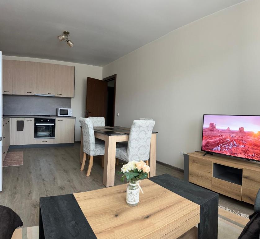 a living room with a table and a television at Tryavna Central Apartments-Relax in Tryavna