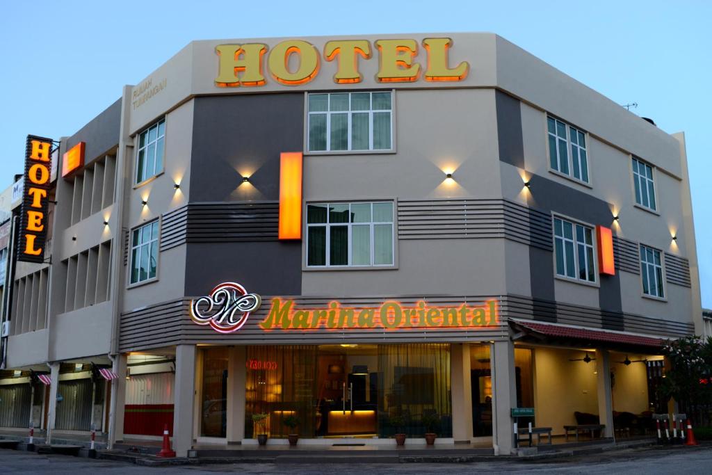 a hotel with a sign on the front of it at Marina Oriental Hotel in Butterworth