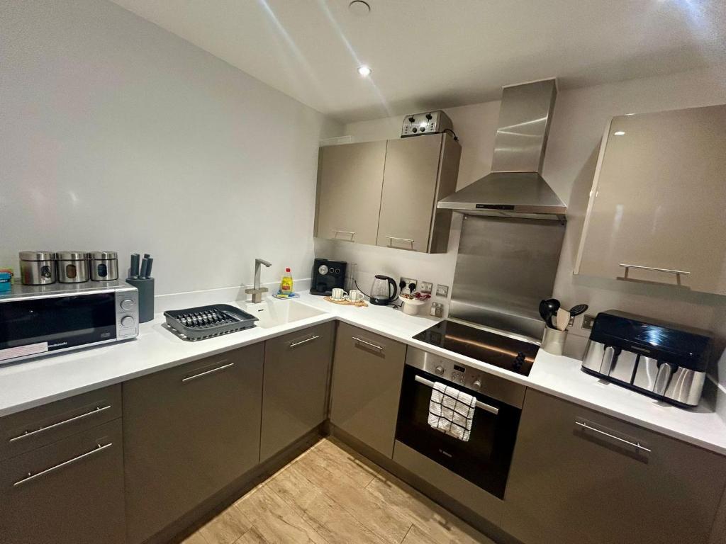 a kitchen with stainless steel appliances and a stove top oven at Apartment 3 in Birmingham