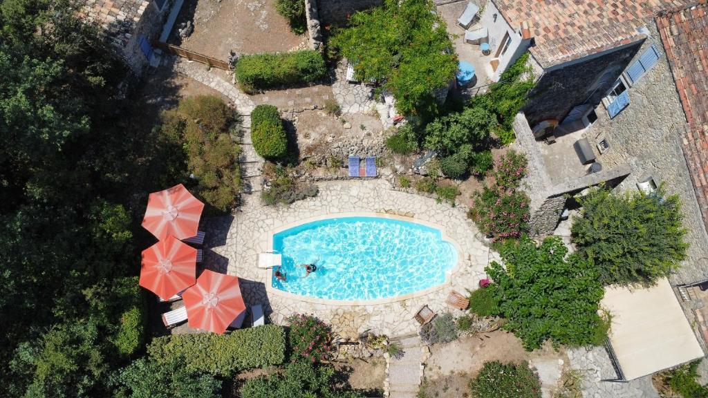 an overhead view of a swimming pool with an umbrella at La Parenthèse du Var - Chambre d'hôtes petits déjeuners inclus et terrasse ombragée in Saint Antonin du Var
