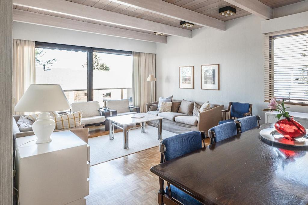 a living room with a couch and a table and chairs at Villa Pulla - House Near Nature & City Center in Rovaniemi