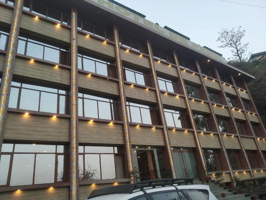 a building with a car parked in front of it at Hotel De Park in Shimla