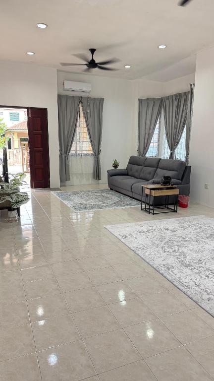 a living room with a couch and a table at Ayu Homestay Kuantan in Beserah