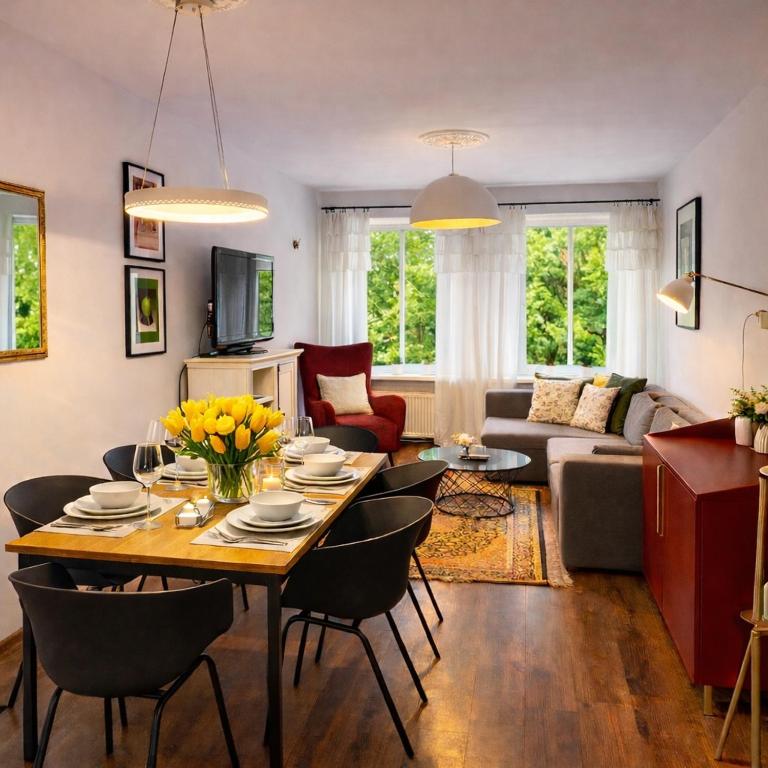 a living room with a table and chairs and a couch at Apartament Zdrój Lądek in Lądek-Zdrój