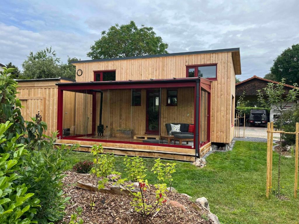 a small wooden house with a red exterior at Tiny Frida in Gifhorn