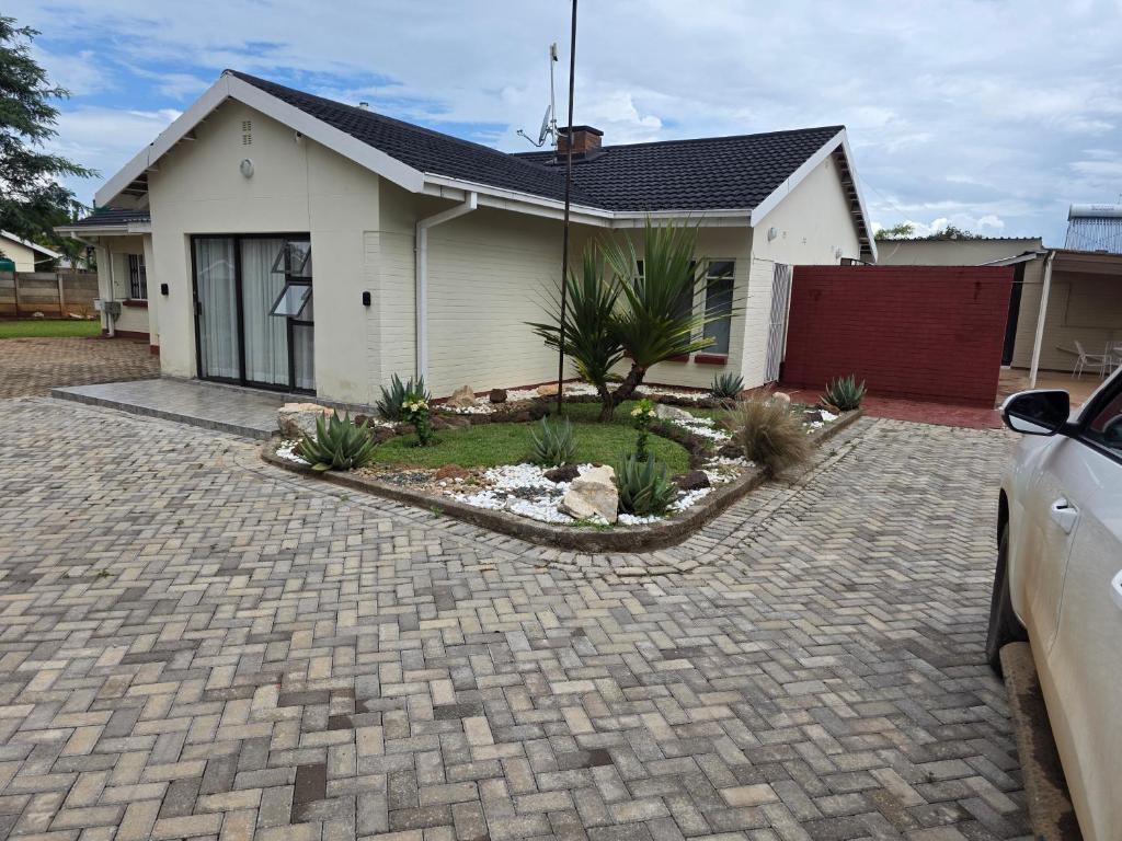 a house with a driveway in front of it at Tranquility Guest House in Bulawayo