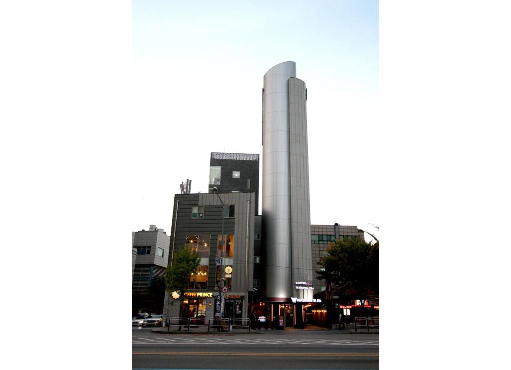 a tall building in the middle of a city at Nabi Hostel in Seoul