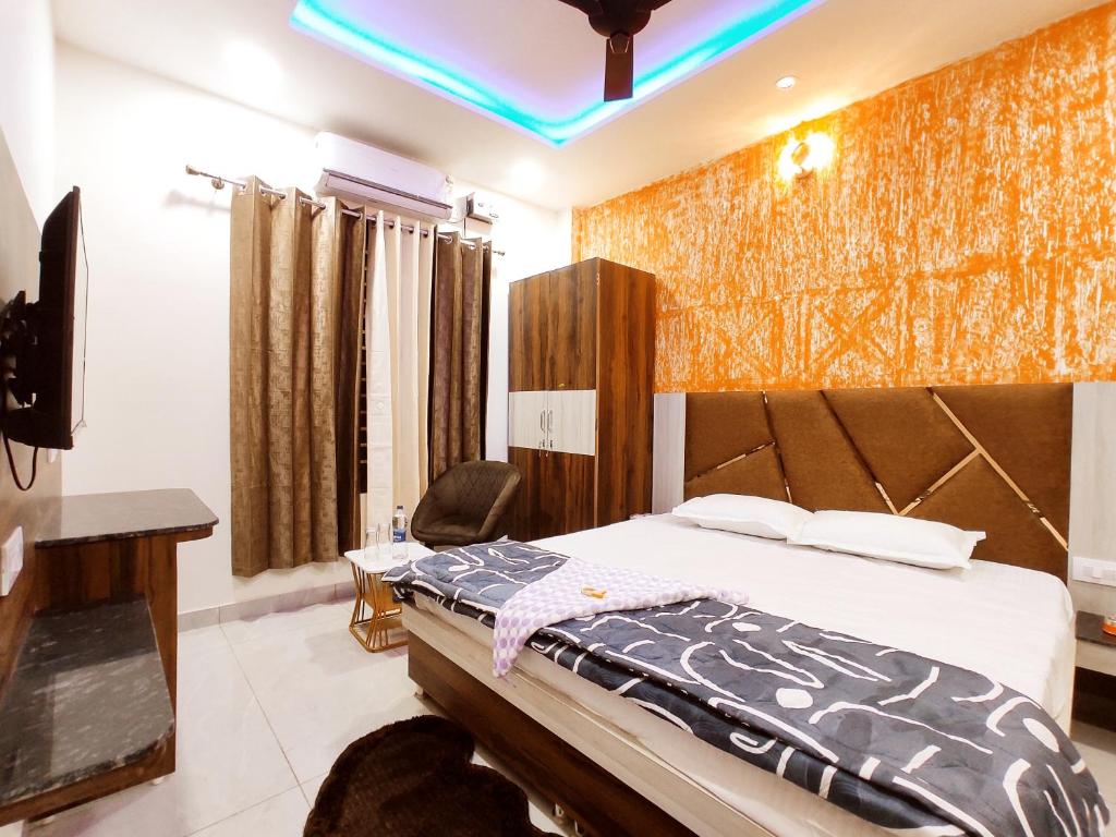 a hotel room with a bed and a television at HOTEL THE VELVET PRIME - Premium & Luxury Suits Rooms in Phagwāra