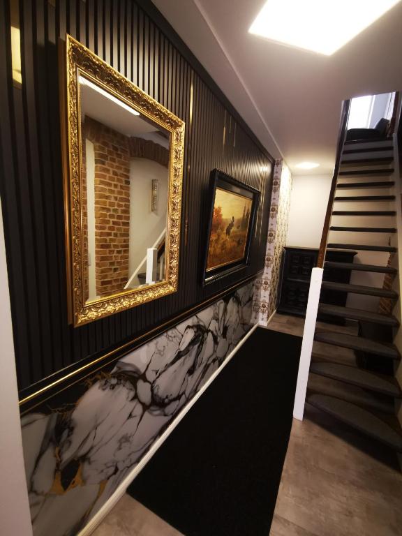 a hallway with a mirror on the wall and stairs at Haus Laila in Heidesee