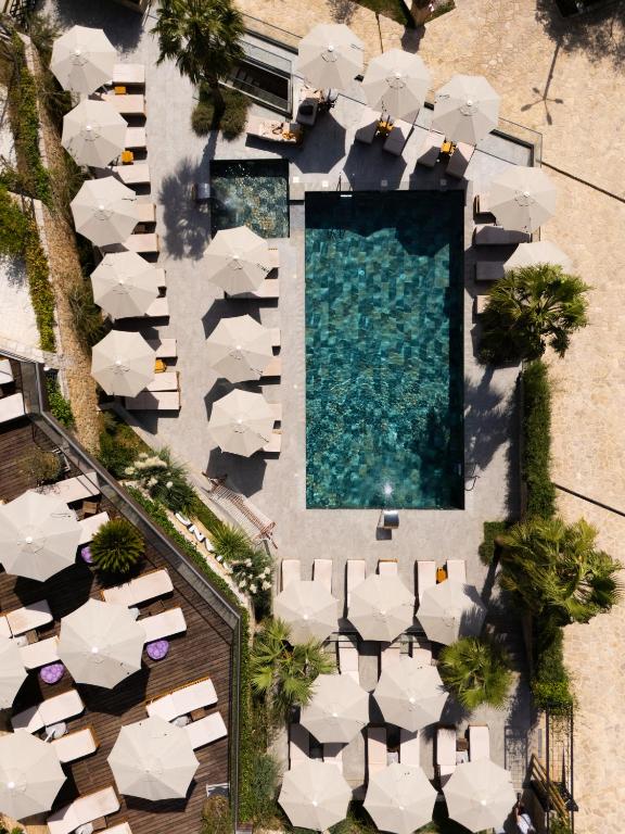 an overhead view of a swimming pool with white umbrellas at Bianca Hotel & Villa Tirana in Tirana