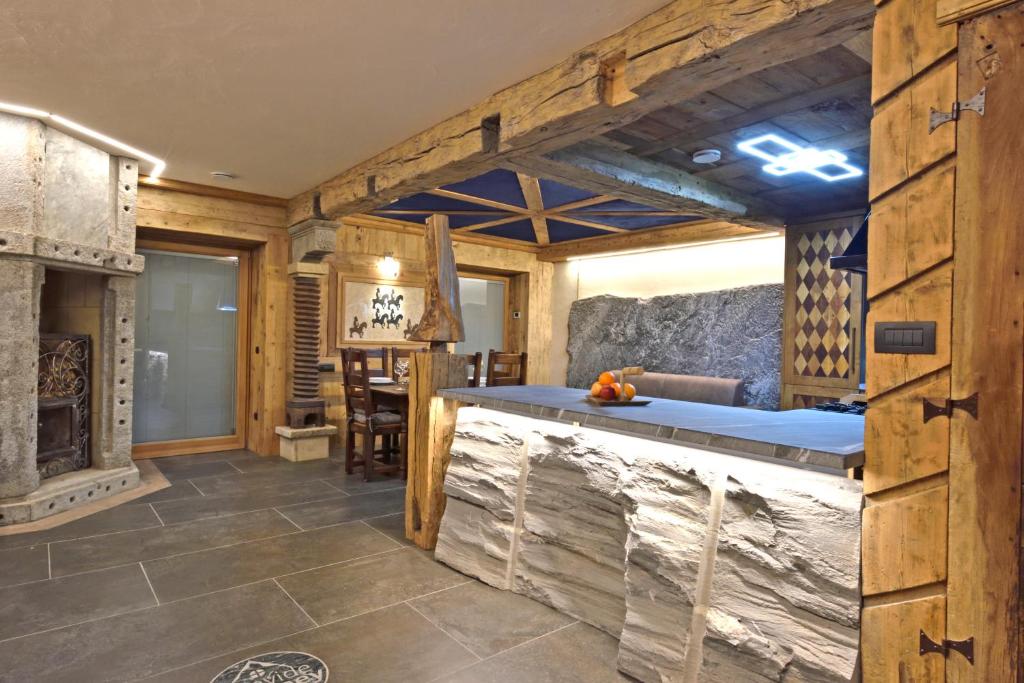 a large room with a fireplace and a stone counter at ArtiStone - "Ancient Lodge" in Saint-Christophe