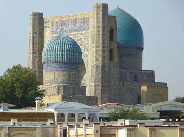 a building with two domes on top of it at Hotel B&S Samarkand Boutique in Samarkand