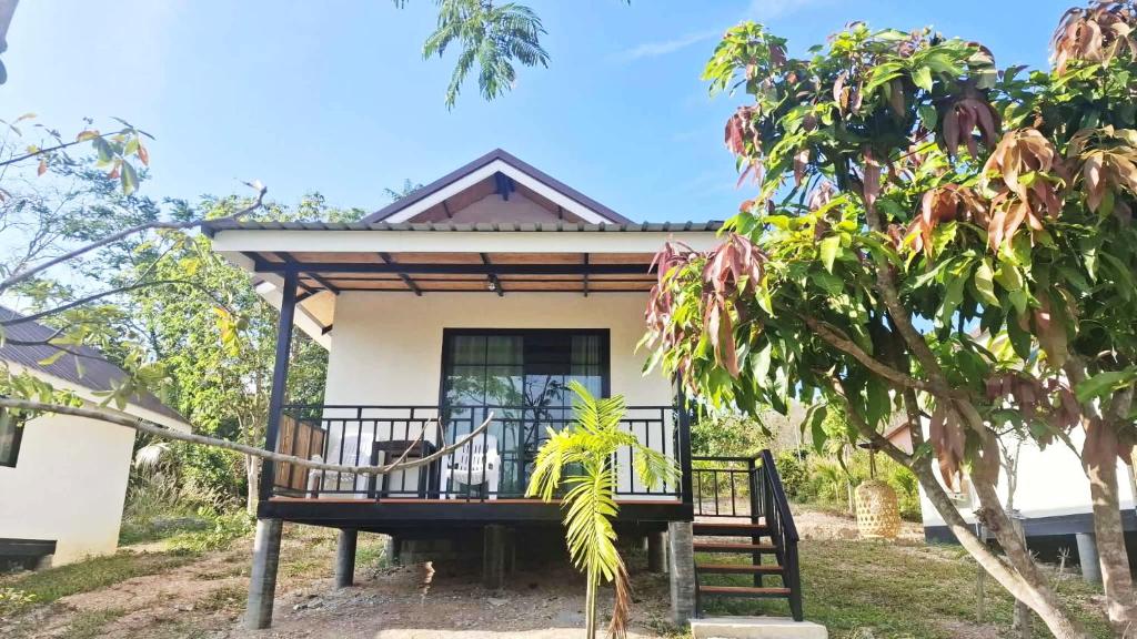 a house with a porch in front of it at TinyHouse at TigerCave in Ko Bu Bu