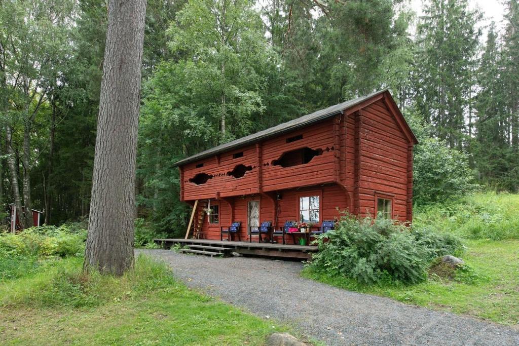 a wooden cabin in the middle of a forest at Getaway in the wilderness in Hämeenlinna