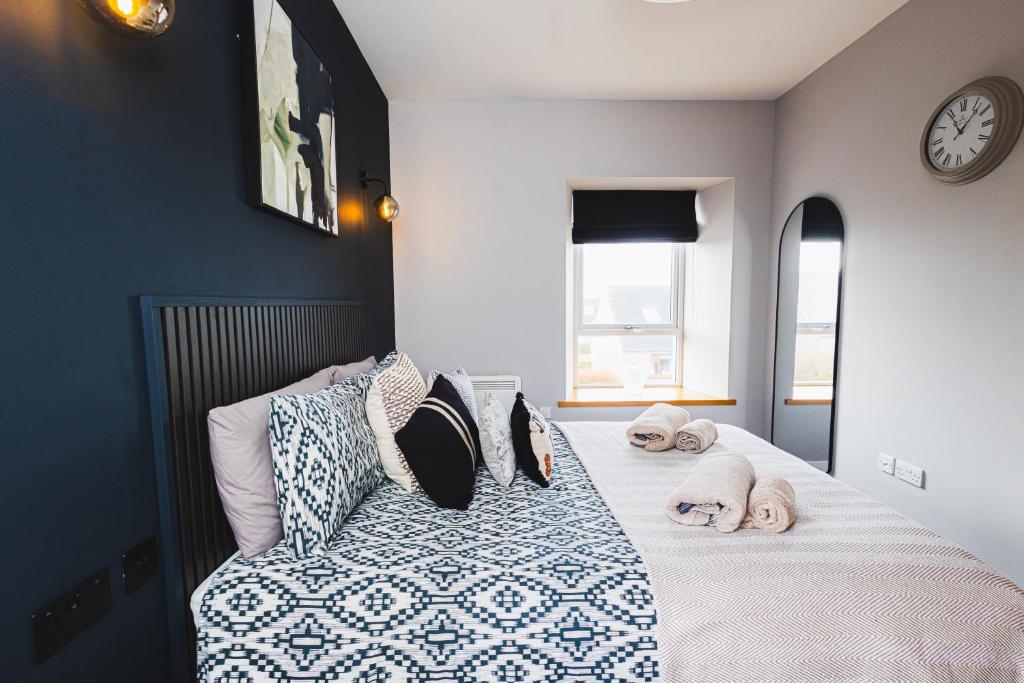 a bedroom with a bed with two dogs on it at Bignold Park View in Orkney