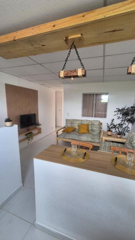 a living room with a couch and a table at Refúgio da Lagoa de Araruama - AP 202 in Araruama