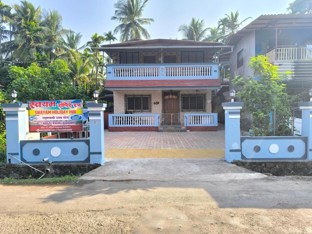 a house with a sign in front of it at Swayam Beach Nivas in Srīvardhan