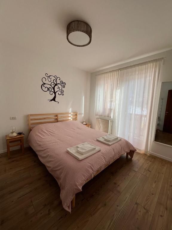 a bedroom with a bed with two towels on it at Al Monte Zelo in Agordo