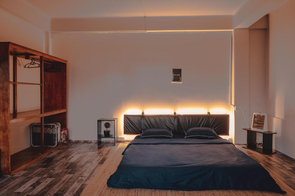 a bedroom with a large bed with lights on the wall at The Southside Den in Āīzawl