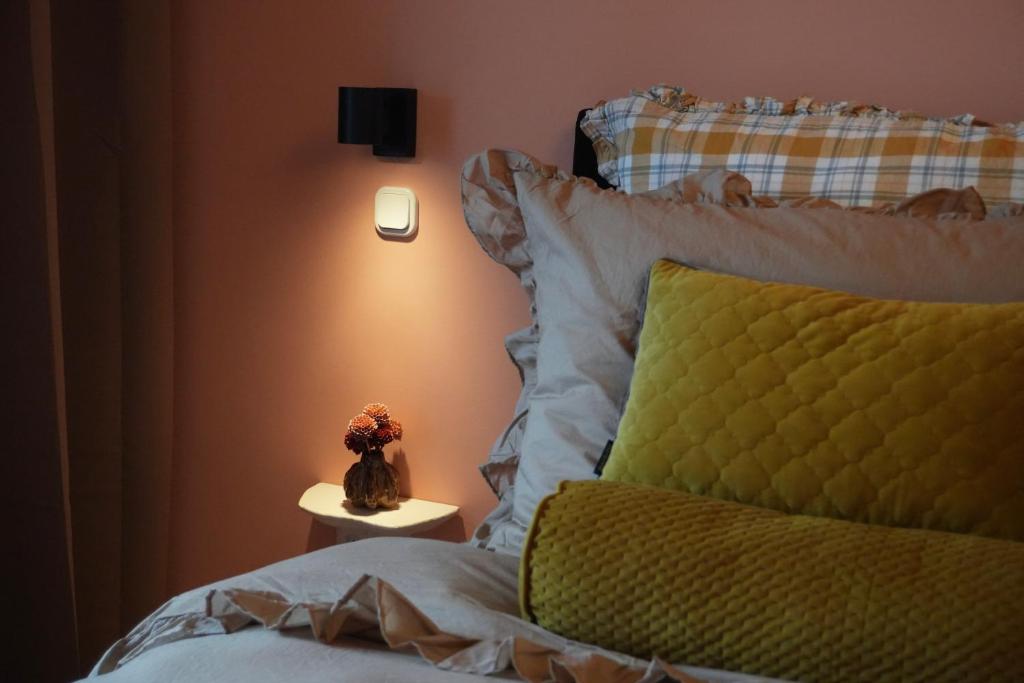 a bedroom with a bed with a green pillow and a lamp at Design Apartment Plön in Plön
