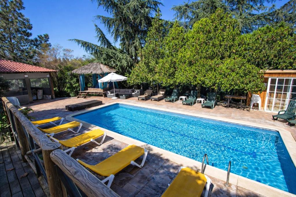 a swimming pool with yellow lounge chairs next to it at Catalunya Casas An oasis for up to 26 nature loving guests! in Sils