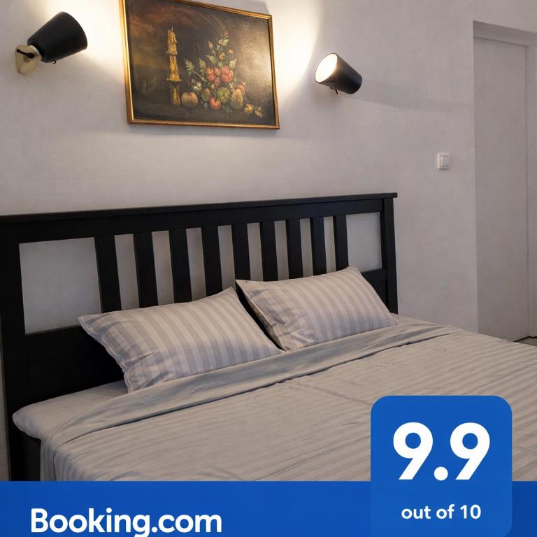 a bedroom with a bed with a picture on the wall at Apartment F.R.I.E.N.D.S in Paraćin
