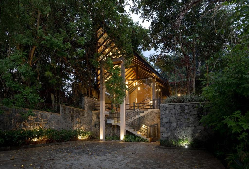 a house with lights on the side of it at Harmony Hills Boutique Villa in Ella