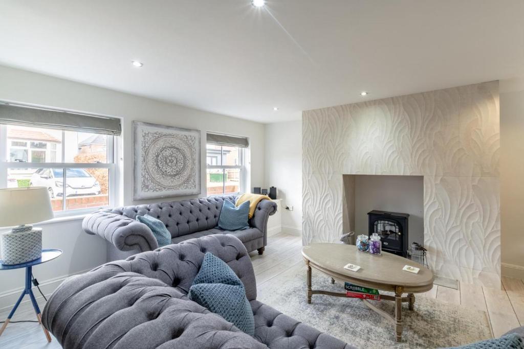a living room with two couches and a fireplace at 1 Bed in Holt oc-1854 in Holt