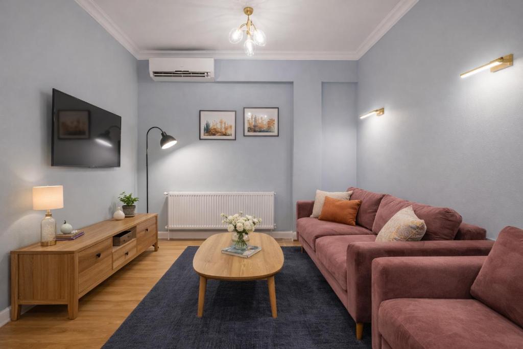 a living room with a couch and a table at City Heart Apartment in Tbilisi City
