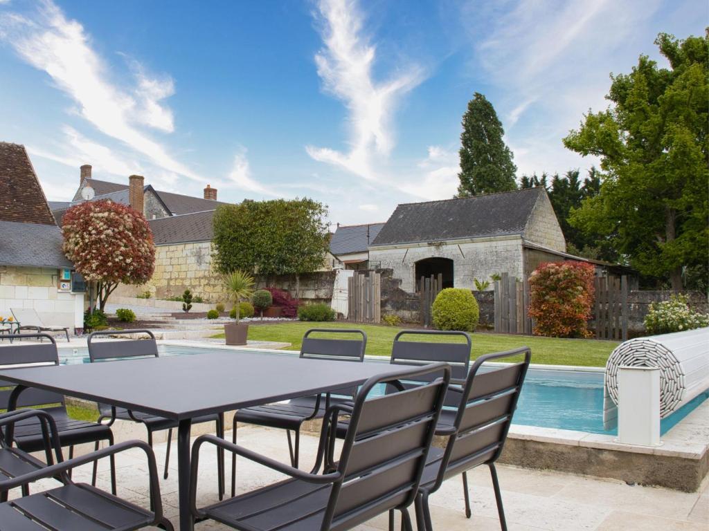 a patio with a table and chairs next to a pool at Cottage l'Orée du Cher in Chissay-en-Touraine