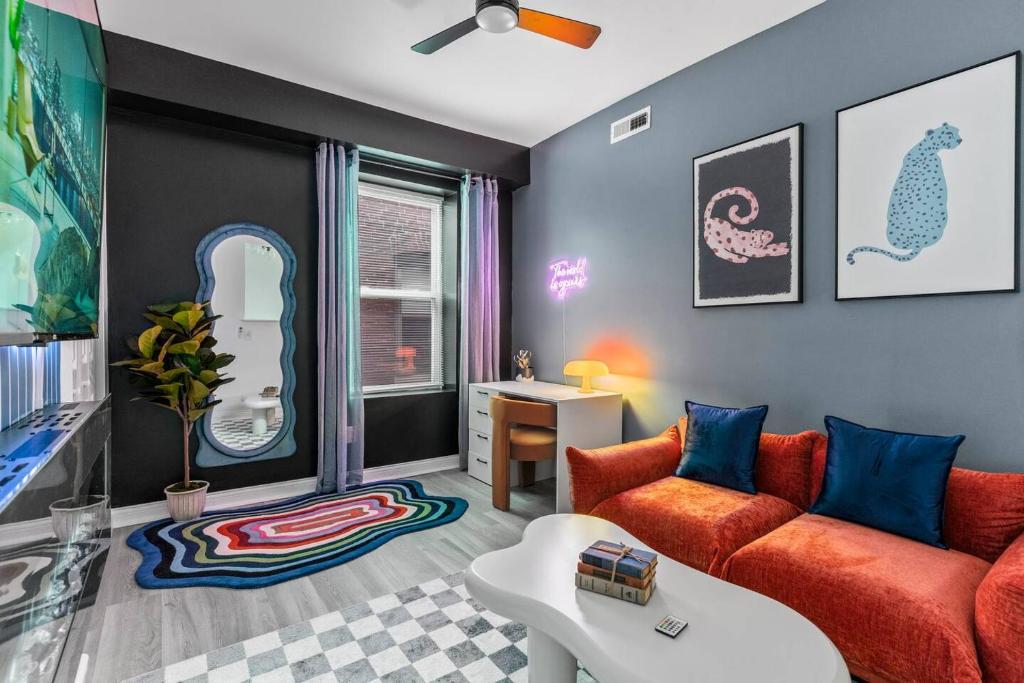 a living room with a couch and a table at Abstract Haven | Stylish 1BR by Tower Grove in Saint Louis