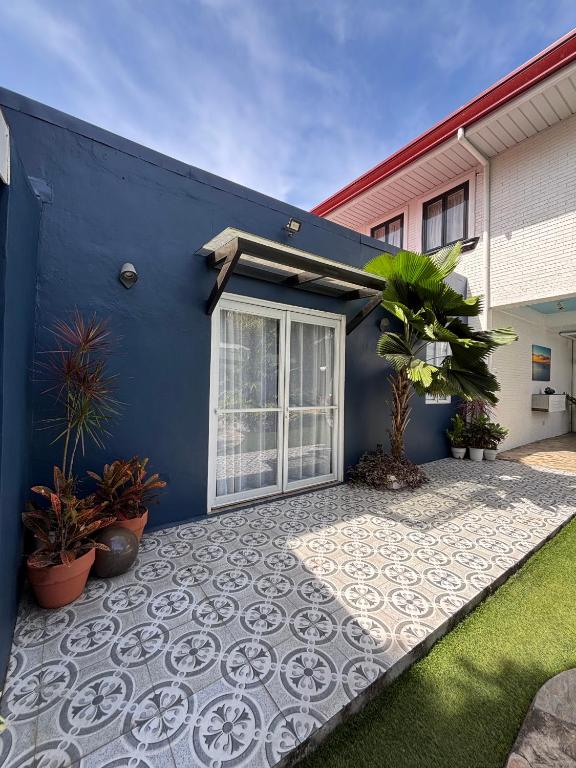 a blue wall with a patio in front of a house at The Barkly House Staycation in Biñan