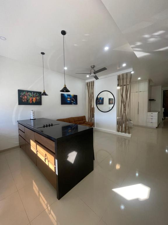 a living room with a black counter and a couch at LOFT 3 Tulum in Mexicali
