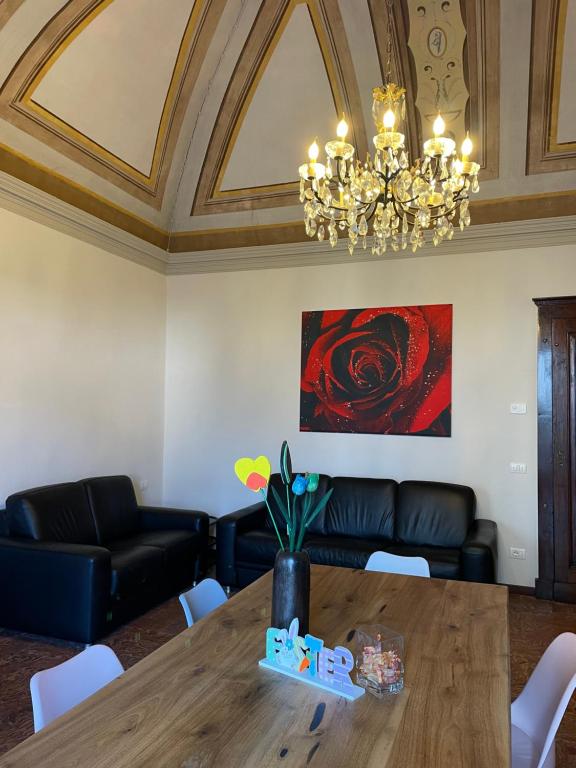 a dining room with a table and a chandelier at Once upon a time in Domaso