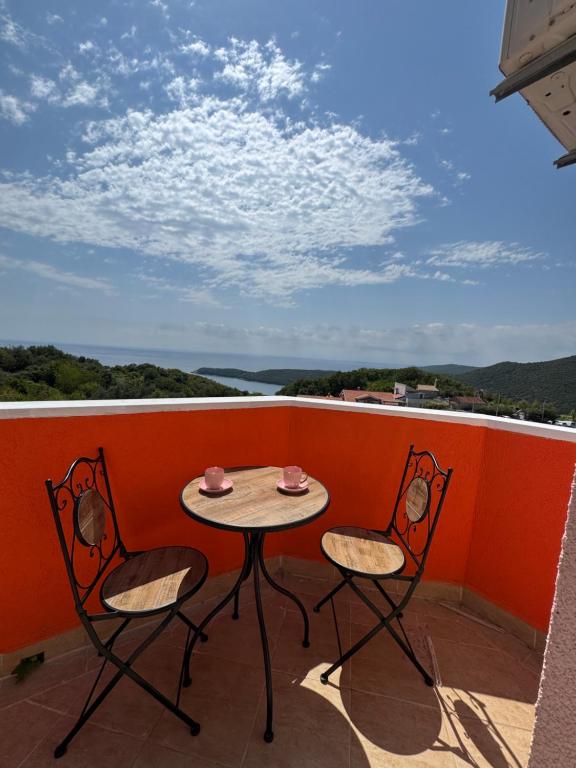 a small table and two chairs on a balcony at Apartman Sunce in Budva