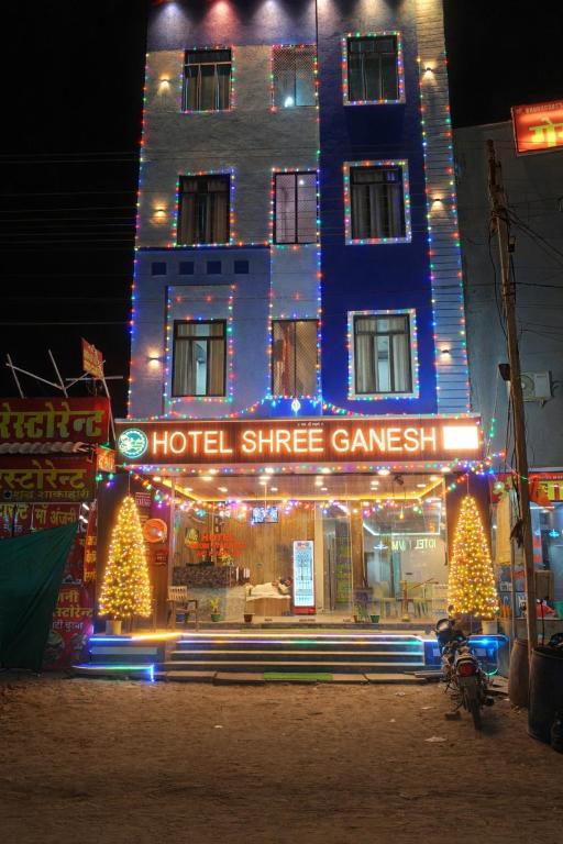a hotel with christmas lights in front of a building at The Shree Ganesh Hotel in Khātu