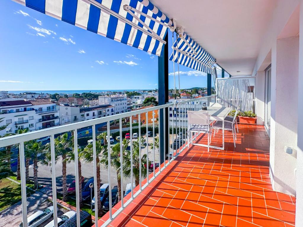 a balcony with chairs and a view of the city at Urban Waves by Hello Homes Sitges in Sitges