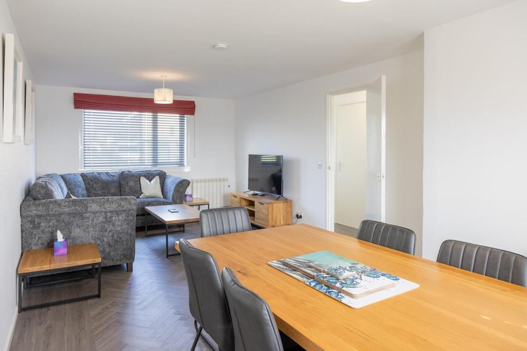 a living room with a table and a couch at Self Catering Accommodation - Balivanich, Sleeps 6 in Balivanich