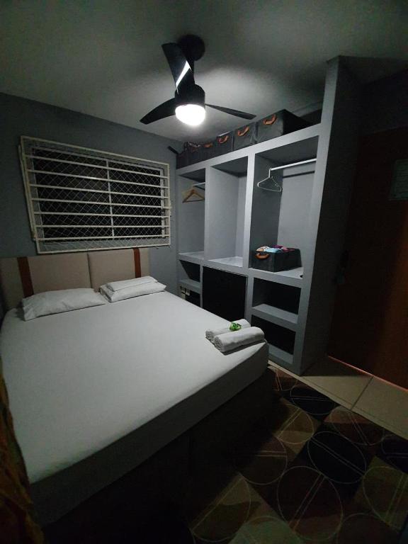 a bedroom with a bed and a ceiling fan at Bedroom Airport in Maceió