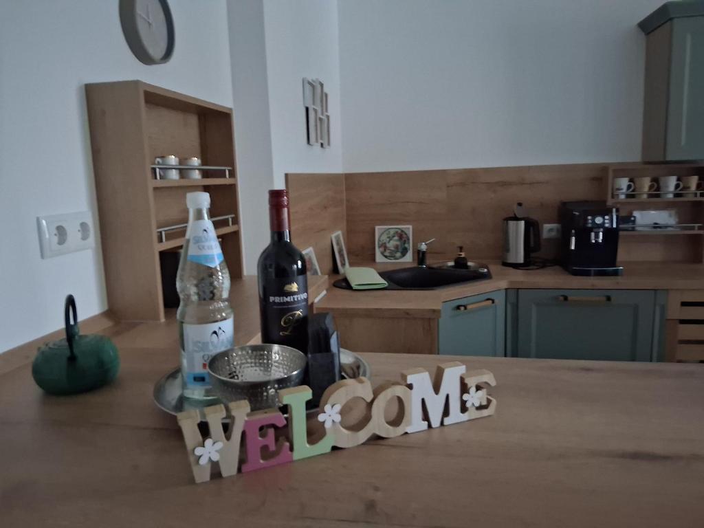 a bottle of wine sitting on a table in a kitchen at Auszeit in Storkow