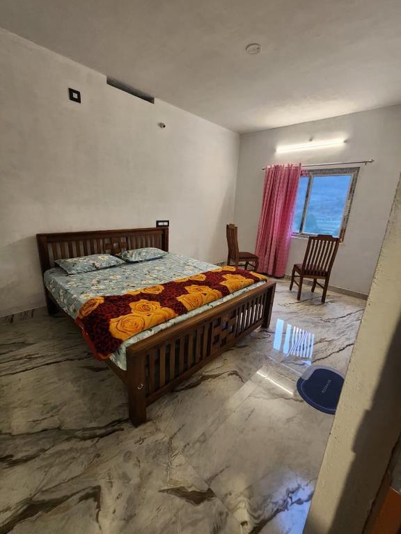 a bedroom with a bed in a room with a window at Brooklyn Homestay in Vattavada