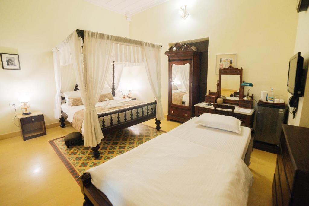 Postel nebo postele na pokoji v ubytování Casa Menezes - A Heritage Goan Homestay