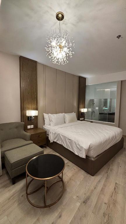 a bedroom with a large bed and a chandelier at Padorama in Nha Trang