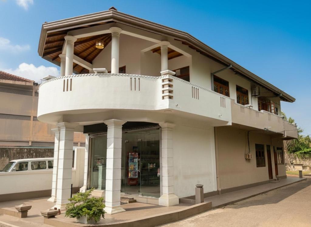 a white house with a balcony on top of it at Sonic Villa,Beruwala in Beruwala