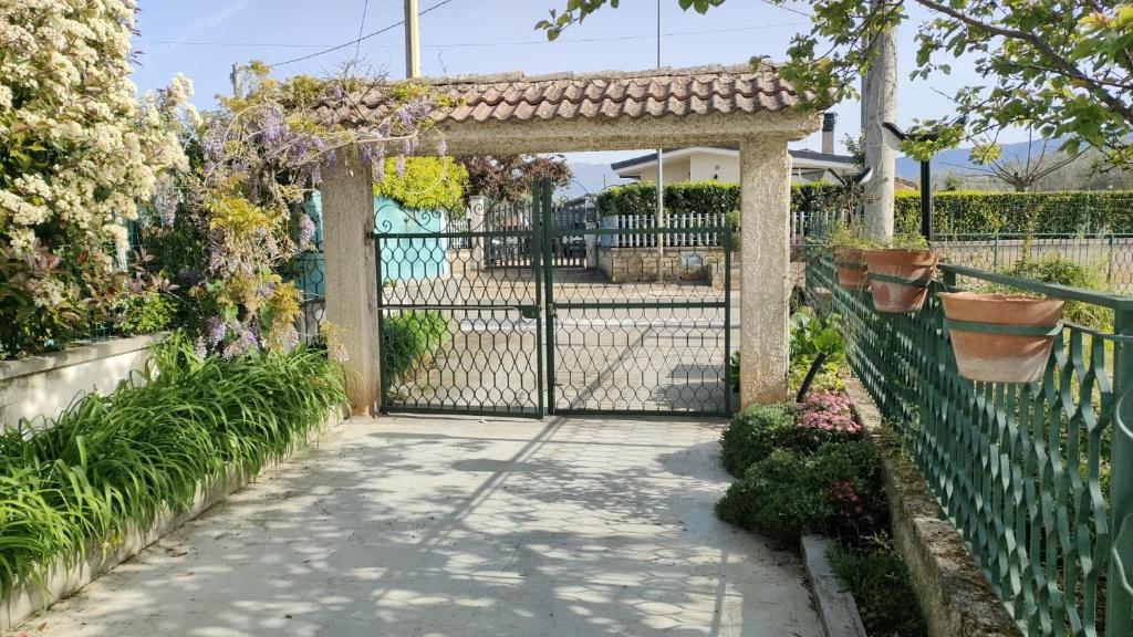 a gate in a garden with plants and flowers at La Candelora Casa Vacanze in Ticchiena