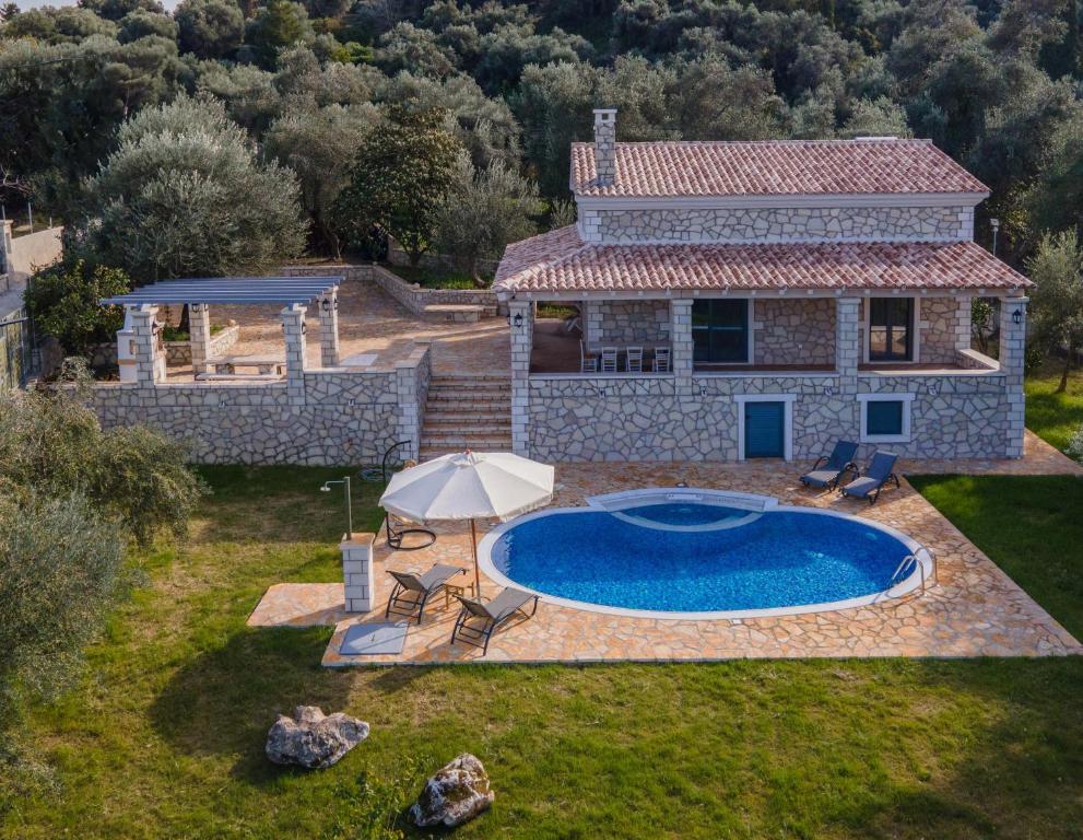 an external view of a house with a swimming pool at Villa Dias by Elayan Villas Corfu in Karousádes