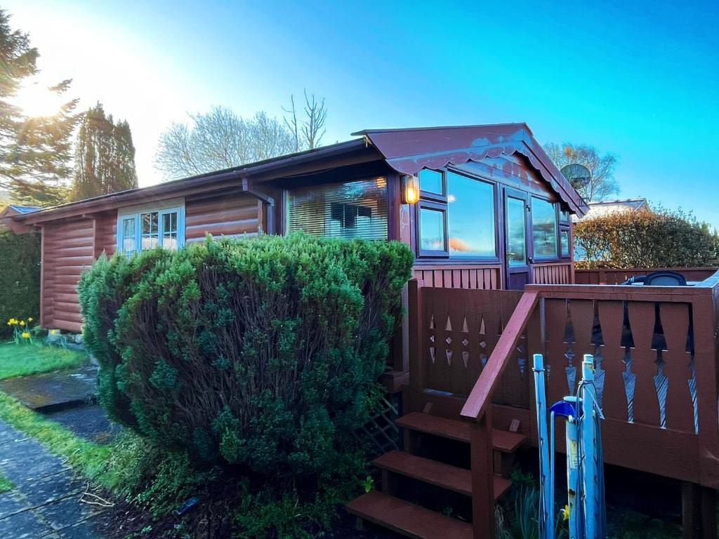 a tiny house with a porch and a wooden fence at Snowdonia Escape in Trawsfynydd