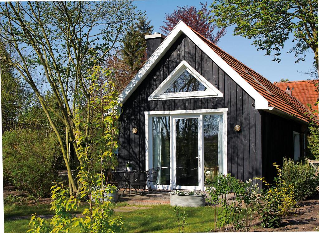a black house with a window on the side of it at Ferienhaus Clara in Wardenburg