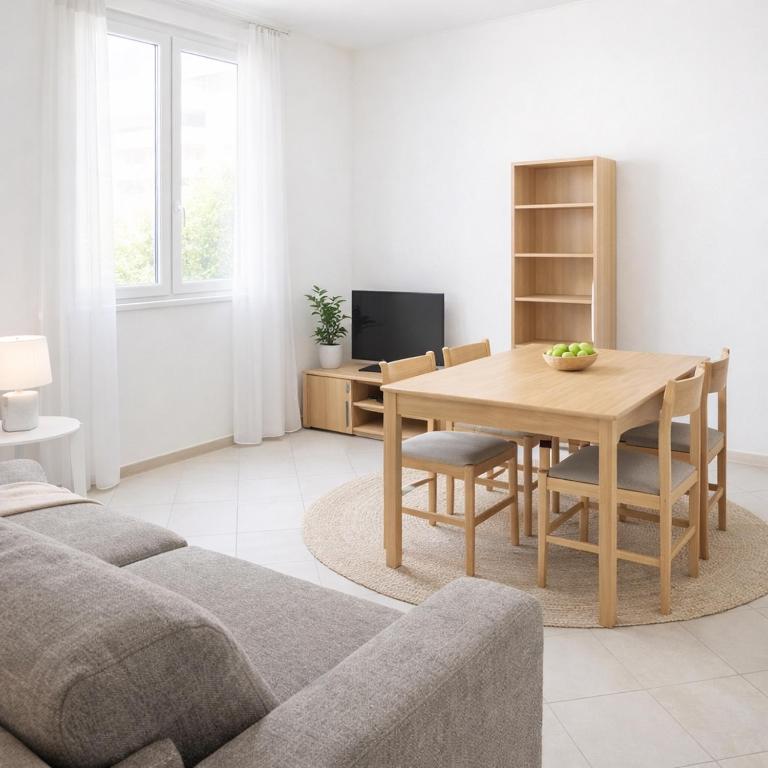 a living room with a table and a couch at ADIGE MUSE HOME in Trento